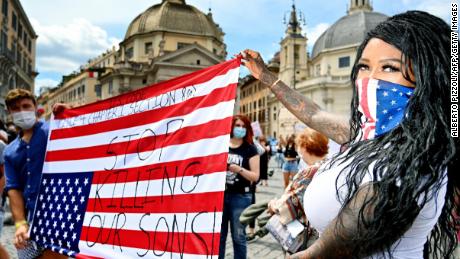 Protesters in Rome are holding the American flag upside down.