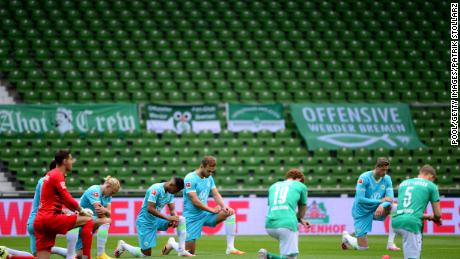 Players of both teams kneel to protest ahead of the Bundesliga match between SV Werder Bremen and VfL Wolfsburg in Germany on Sunday.