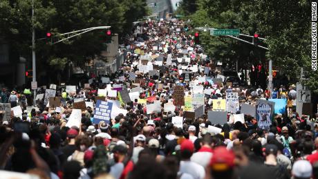 People are marching through the streets during a June 16 event organized by the One Race Movement in Atlanta, Georgia.