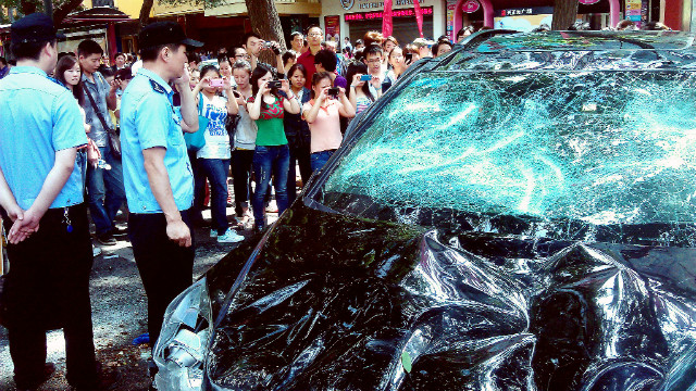 People photograph a Japanese car damaged during a protest against the nationalization of Japan. disputed islands of Diaoyu, also known in Japan as the Senkaku Islands, in the Chinese city of Xi & # 39; September 15, 2012 