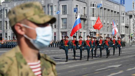 A Russian soldier wears a mask in Lenin Square during a parade.