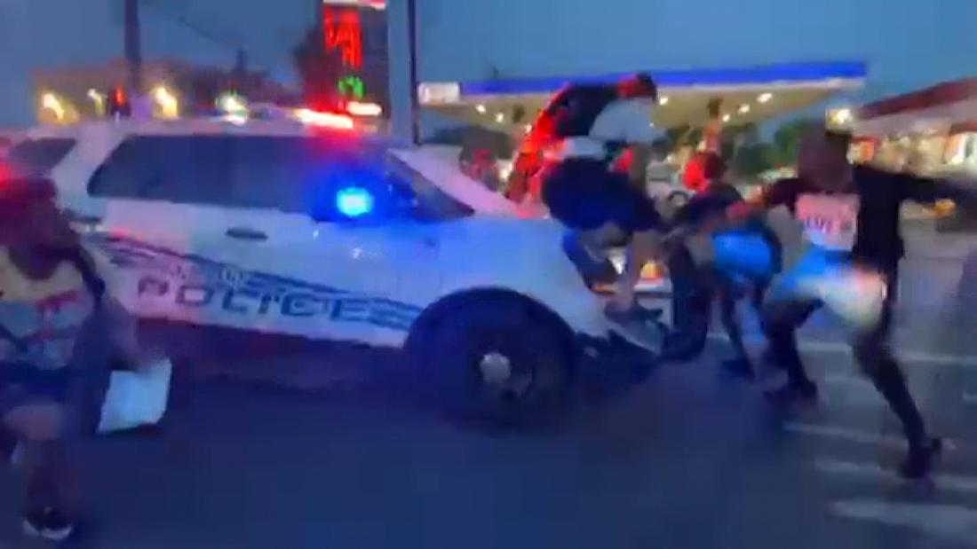 A video has appeared showing a Detroit police car driving into the protesters