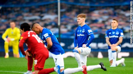 Players and officials kneel in a sign of the Black Lives Matter movement ahead of the Merseyside derby between Everton and Liverpool at Goodison Park. 