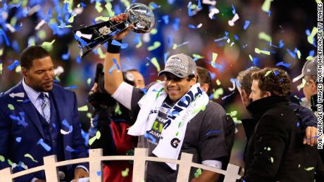 Wilson celebrated with Vince Lombardi’s trophy after beating the Denver Broncos 43-8 in the 2014 Super Bowl XLVIII 2014. 