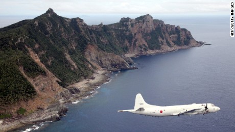 A Japanese military plane flies over Senakuku / Diaoyu Island in this file.