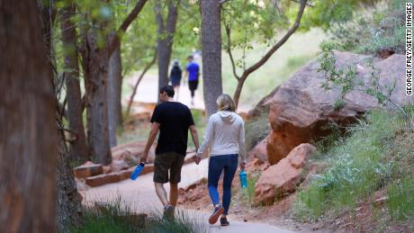 Hikers walking on a paved trail in Zion National Park in Utah, Utah, which was closed due to a pandemic.