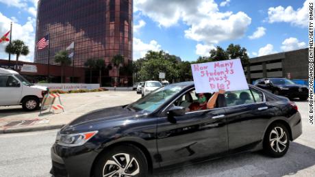 Teachers protested in front of central Florida County Public Schools in Orange.