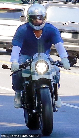 Geared up: Pitt geared up for the gorgeous summer ride in a silver motorcycle helmet and a pair of white riding gloves