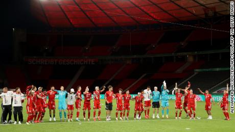 Bayern players celebrate winning the German Cup in a completely empty Olympiastadion.