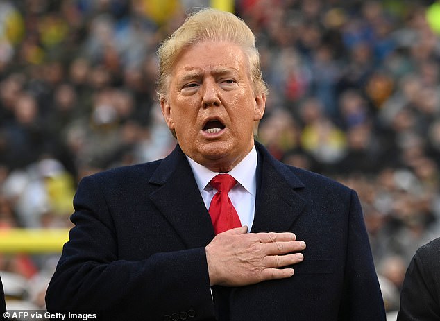 Trump pictured singing the anthem before the Army-Navy game in Philadelphia last December