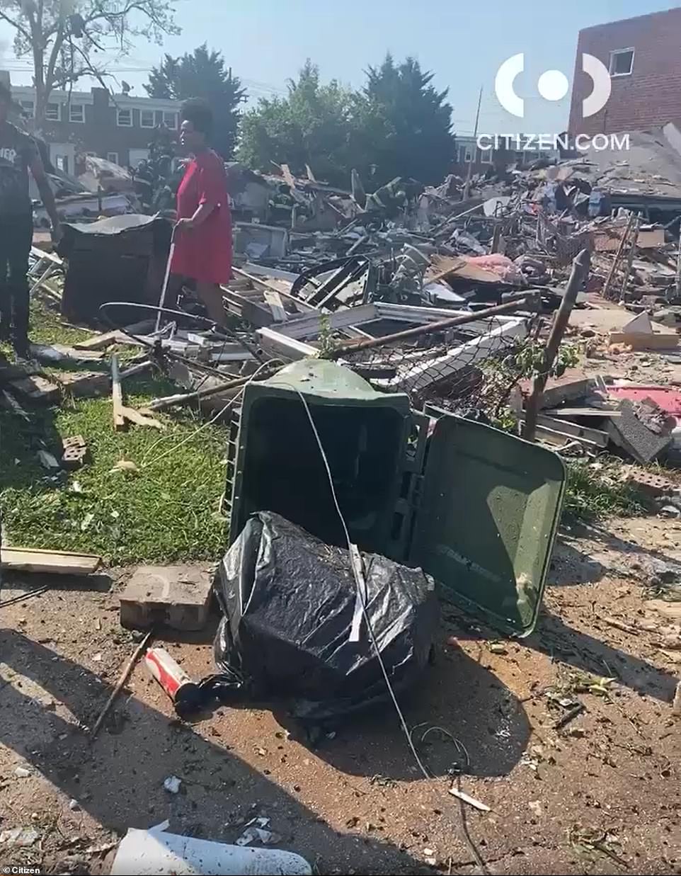 At least one person has been killed and another two are in a critical condition after a 'major explosion' destroyed at least three homes in Baltimore and trapped victims, including children, under the rubble. Pictured: the scene