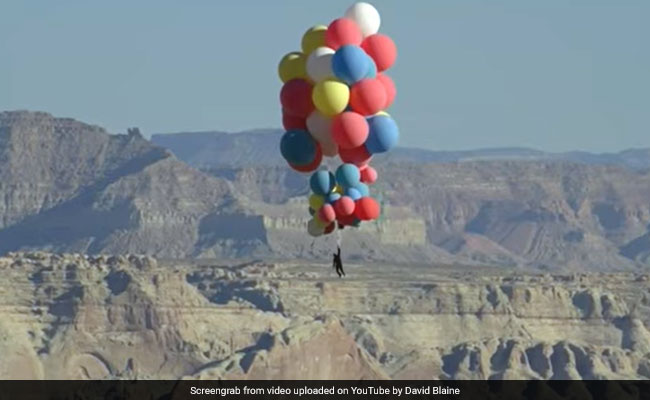 Dardeville flies through the sky with 52 helium balloons.  Watch