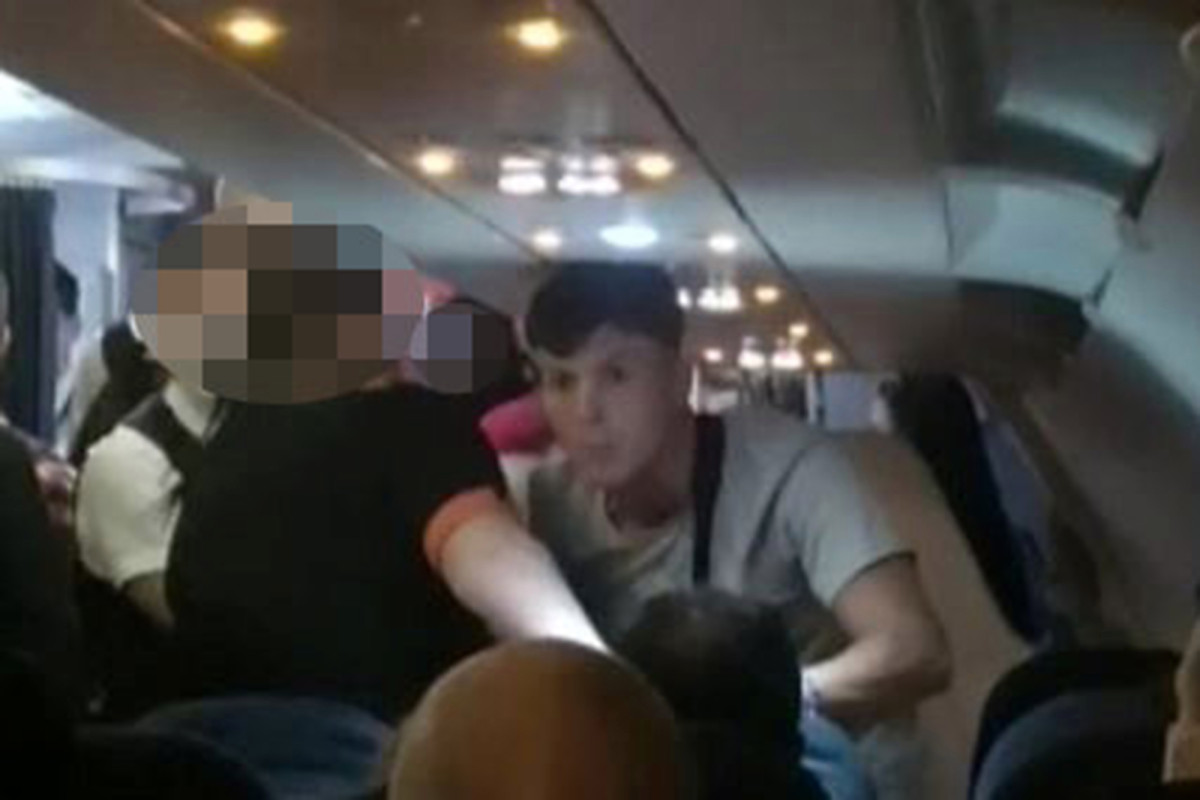 A video of a plane passenger punching a woman in an alleged racist attack