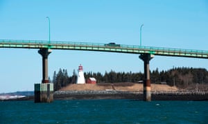 Cars cross the international bridge between Lübeck, Maine (left) and Campobello Island, Canada on March 3, 2017. Lübeck is the easternmost city in the United States bordering it with a border crossing with Canada.  Credit: AFP PHOTO / Don Emmer