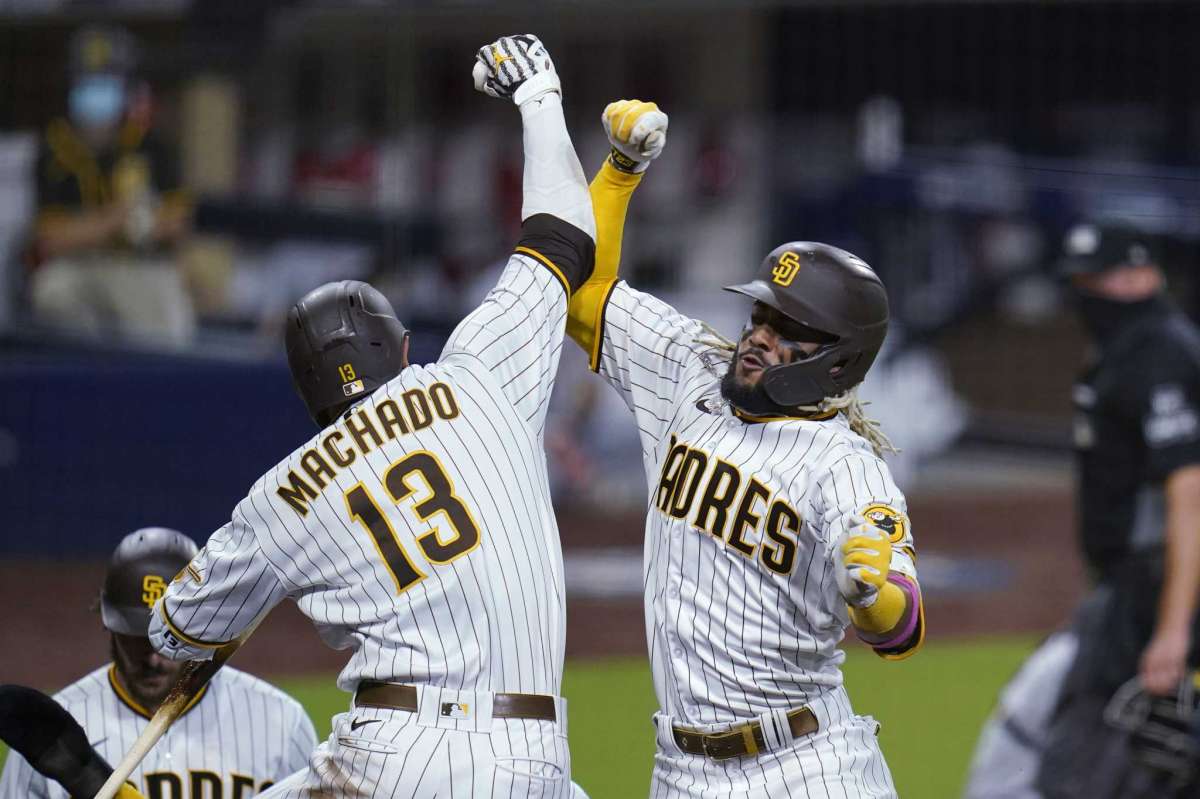 Fernando Tatis Jr. of San Diego Padres, right, was congratulated by Mane Machado, left, after he scored three rounds at home during the sixth inning of the second game of the National League Series baseball wild cards for the team against the St. Louis Cardinals, Thursday, 1 October, 2020, in San Diego.