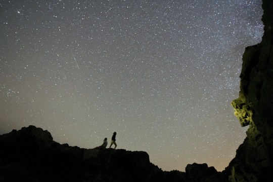 Mandatory credit: Photo by Carlos De Saa / EPA / REX (8109478a) Hikers admire the starry skies during the meteoric delta showers on El Valle beach in Fuerteventura, Canary Islands, Spain early morning July 27, 2014 Spain Betancuria (Fuerteventura) Spain Delta Aquarids Meteor Shower - July 2014