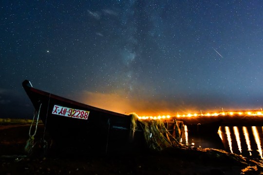 Vladivostok, Russia?  October 10, 2018: A meteor breaks through the night sky over Rusky Island during the Draconide meteor shower.  Yuri Smituk / TASS
