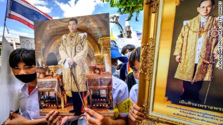 Protesters hold pictures of Thailand's King Maha Vajiralongkorn and his late father, King Bhumibol Adulyadej, during a pro-government and monarchy rally in Bangkok, July 30, 2020.