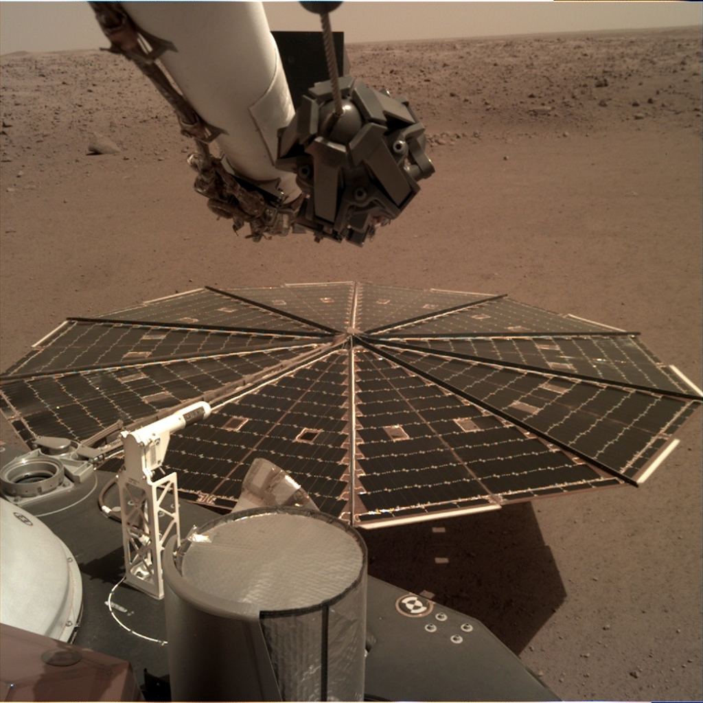 One of two 7-foot-wide (2.2 m) solar panels were photographed by the landing gear deployment camera, which is mounted on the elbow of its robotic arm.  The accumulation of dust on the panels reduced the energy available to the mission.  Source: NASA / JPL-Caltech