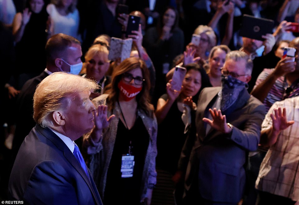 Worshipers stood around President Donald Trump and prayed for him in Nevada on Sunday as he attended mass at Las Vegas International Church.