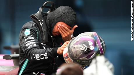 Emotional Hamilton celebrates with the Mercedes after the race. 
