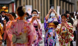 Vacationers in kimono dress take photos in Asakusa, downtown Tokyo, Japan, November 23, 2020, the last day of the three-day holiday.