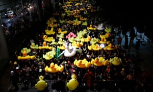 Protesters carry inflatable ducks on their way to the 11th Infantry Barracks.