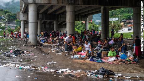 People forced from their homes in the San Pedro Sula Valley due to flooding in the aftermath of Hurricane ETA have taken refuge in a makeshift camp under an overpass in Chimelikon, Honduras.