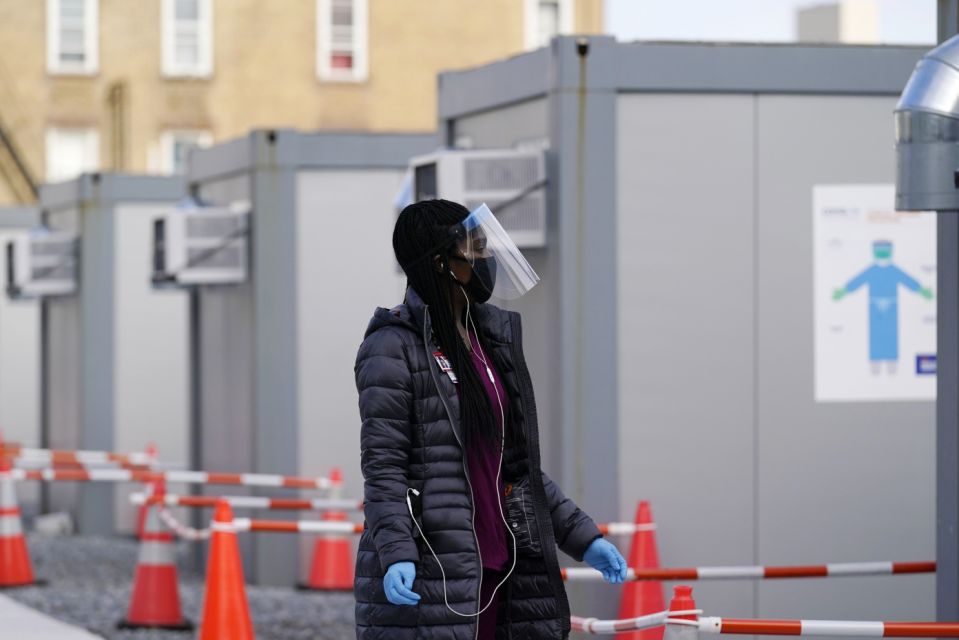 A worker wearing a face shield walks between portable units intended for registration and testing at the New York City COVID-19 Test Site for Hospitals + Health in the Brooklyn area of ​​New York, Thursday, November 19, 2020. (AP Photo / Cathy Wellins)