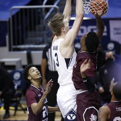 BYU Center Matt Harms (3) dunks the ball while surrounded by a trio of South Texas defenders during the Cougars 87-71 victory at the Marriott Center in Provo on Monday, December 21, 2020.