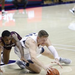 BYU striker Kolby Lee (40) dives to the ground for a loose ball as Cougars 87-71 beat Texas Southern at the Marriott Center in Provo on Monday, December 21, 2020.
