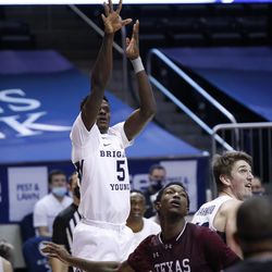 BYU striker Gideon George (5) places a shot against South Texas striker Gordon Carl Nicholas (5) during the Cougars 87-71 victory at the Marriott Center in Provo on Monday, Dec. 21, 2020.