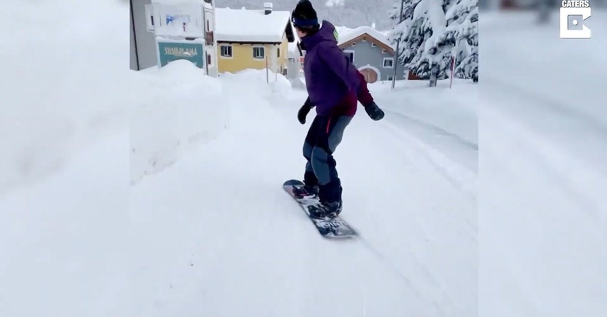 Disconnect.  – This man is skiing in the snow-covered streets of Switzerland