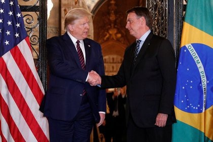 Presidents of the United States and Brazil, Donald Trump (left) and Jair Bolsonaro, shake hands before attending a business dinner at Mar-a-Lago Resort, Palm Beach, Florida, USA.