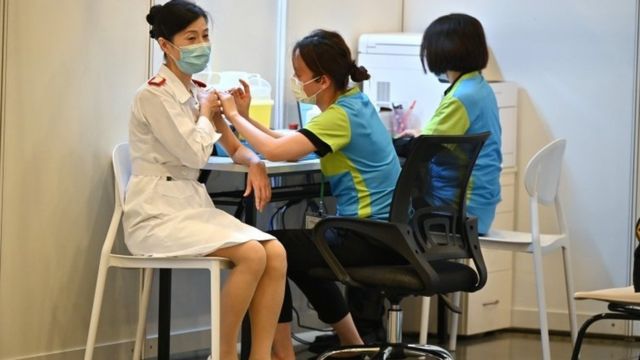 Hong Kong's COVID-19 vaccination programme: A healthcare worker is given a COVID-19 vaccine at a clinic in Hong Kong, China, February 23, 2021.