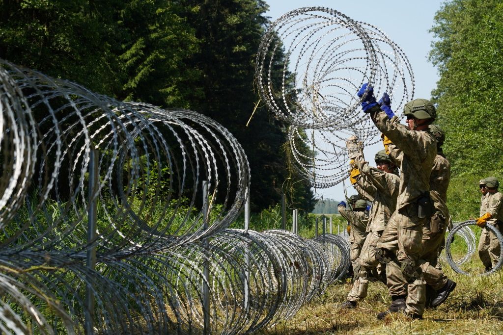 Vilnius says Belarusian border guards have breached the border and pushed migrants into Lithuania