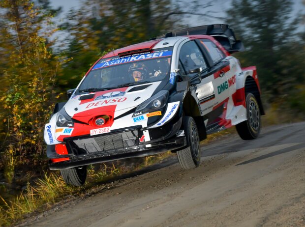 Sebastien Ogier jumps in his Toyota at the Rally Finland