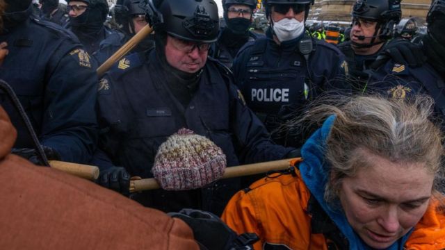 Police expel a protester in Ottawa