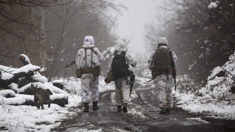 Ukrainian soldiers walks at the line of separation from pro-Russian rebels near Katerinivka, Donetsk region, Ukraine, Tuesday, Dec 7, 2021. Ukrainian authorities on Tuesday charged that Russia is sending tanks and snipers to the line of contact in war-torn eastern Ukraine to 