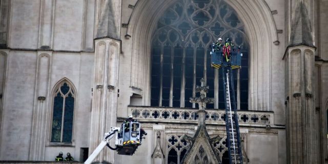 The fire shattered stained glass windows and sent black smoke spewing from between its two towers of the 15th-century cathedral, which also suffered a serious fire in 1972.