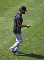 Marlins manager Don Mattingly walks to the mound during a pitching change.
