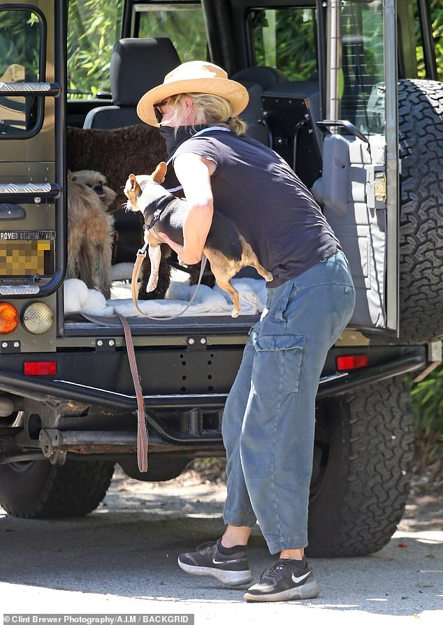 Attentive: Portia huddled her dogs into the back of her vehicle