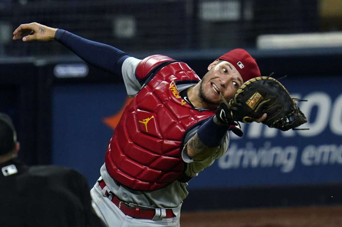 St.Louis Cardinals hunter Yadier Molina picks up a foul ball out on Eric Hosmer of the San Diego Padres team during the eighth round of the second game of the National League Baseball Series, Thursday October 1, 2020, in San Diego.