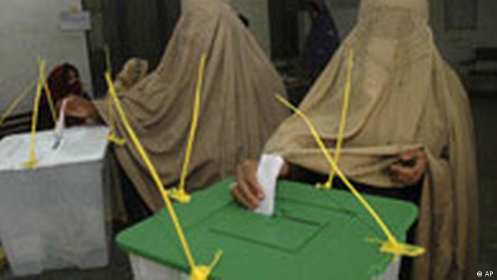Burqa-clad women vote in Pakistan's parliamentary elections.  (AFP)